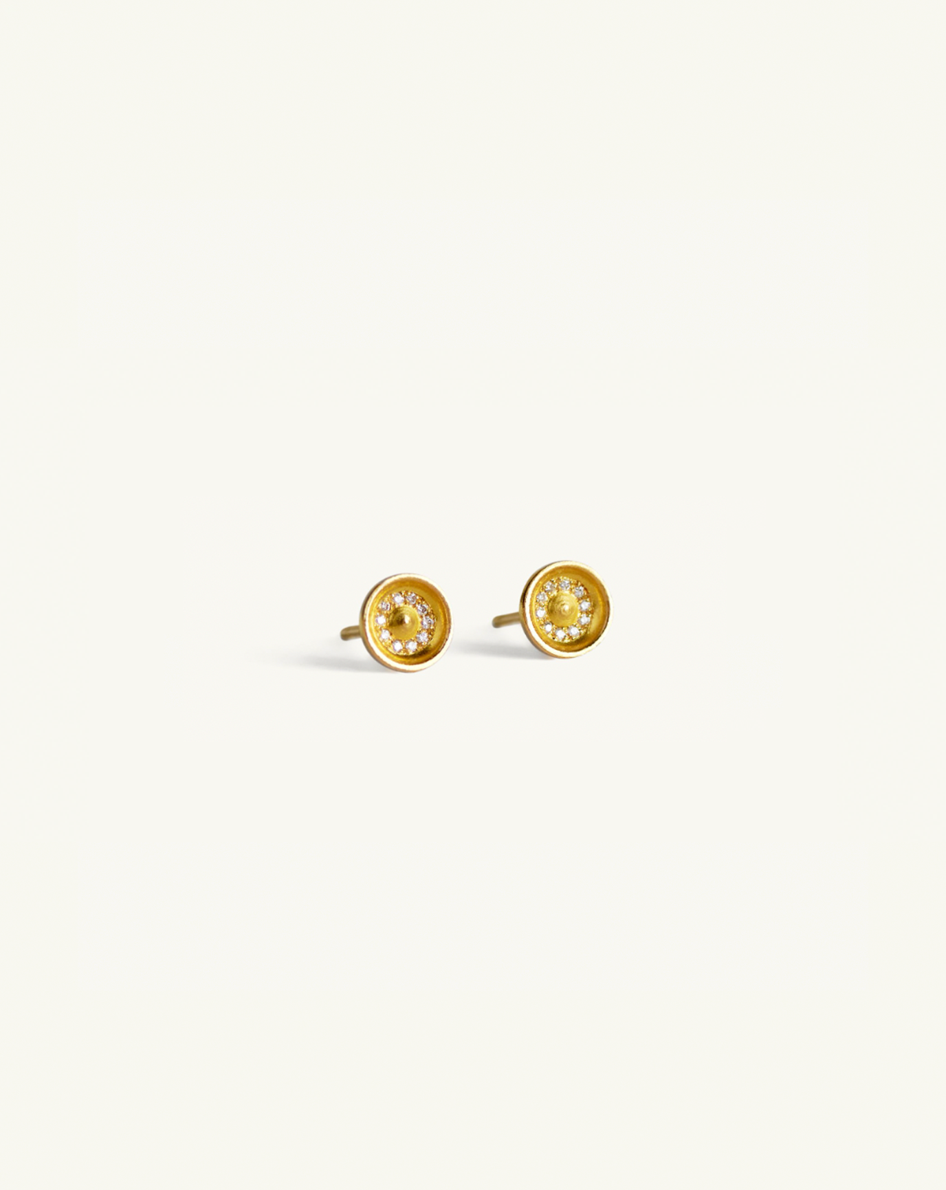 Product image of the large concave gold studs with white diamond pavé