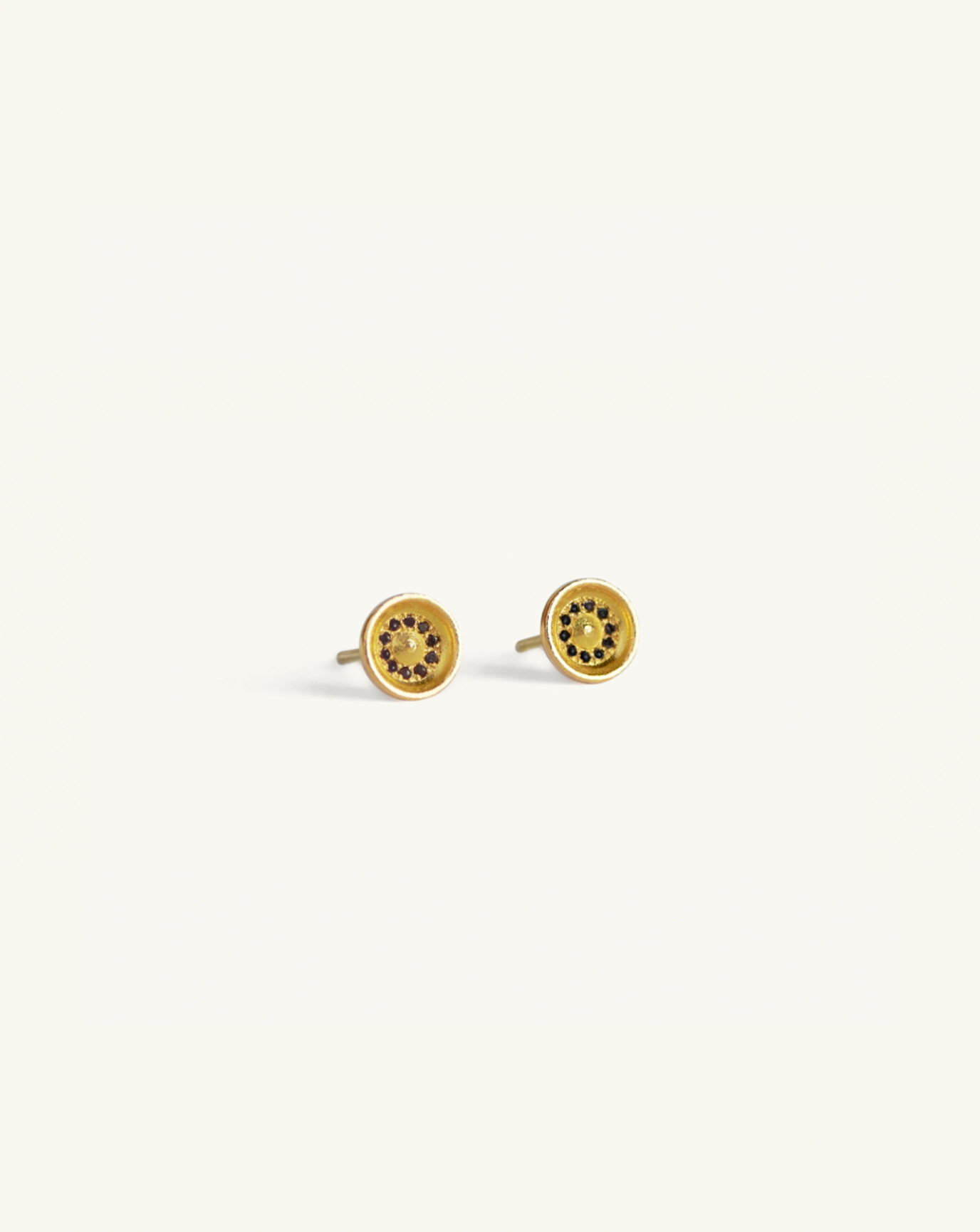 Product image of the large concave gold studs with black diamond pavé