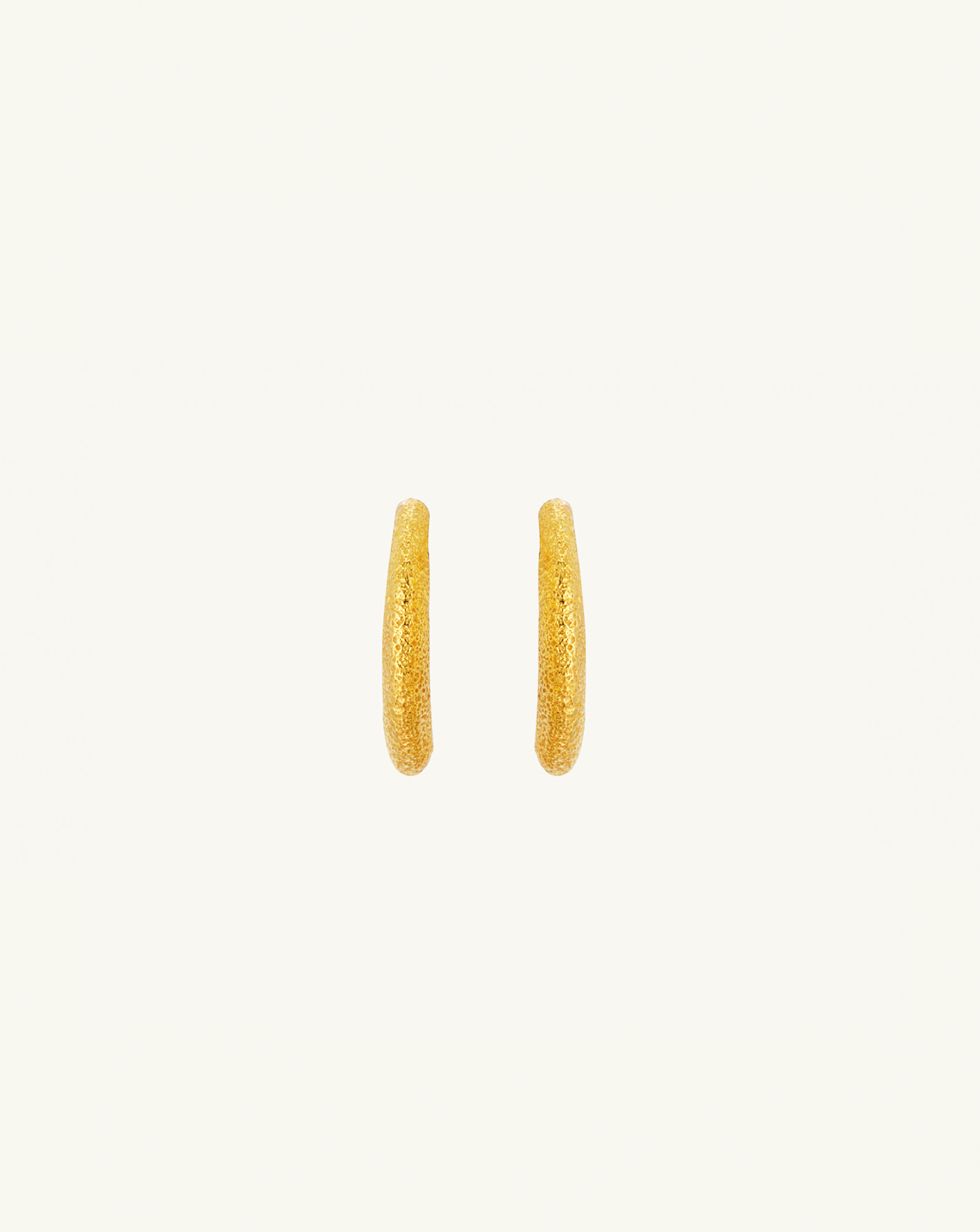 Straight-on product image of the medium sized asymmetric hoops with textured gold