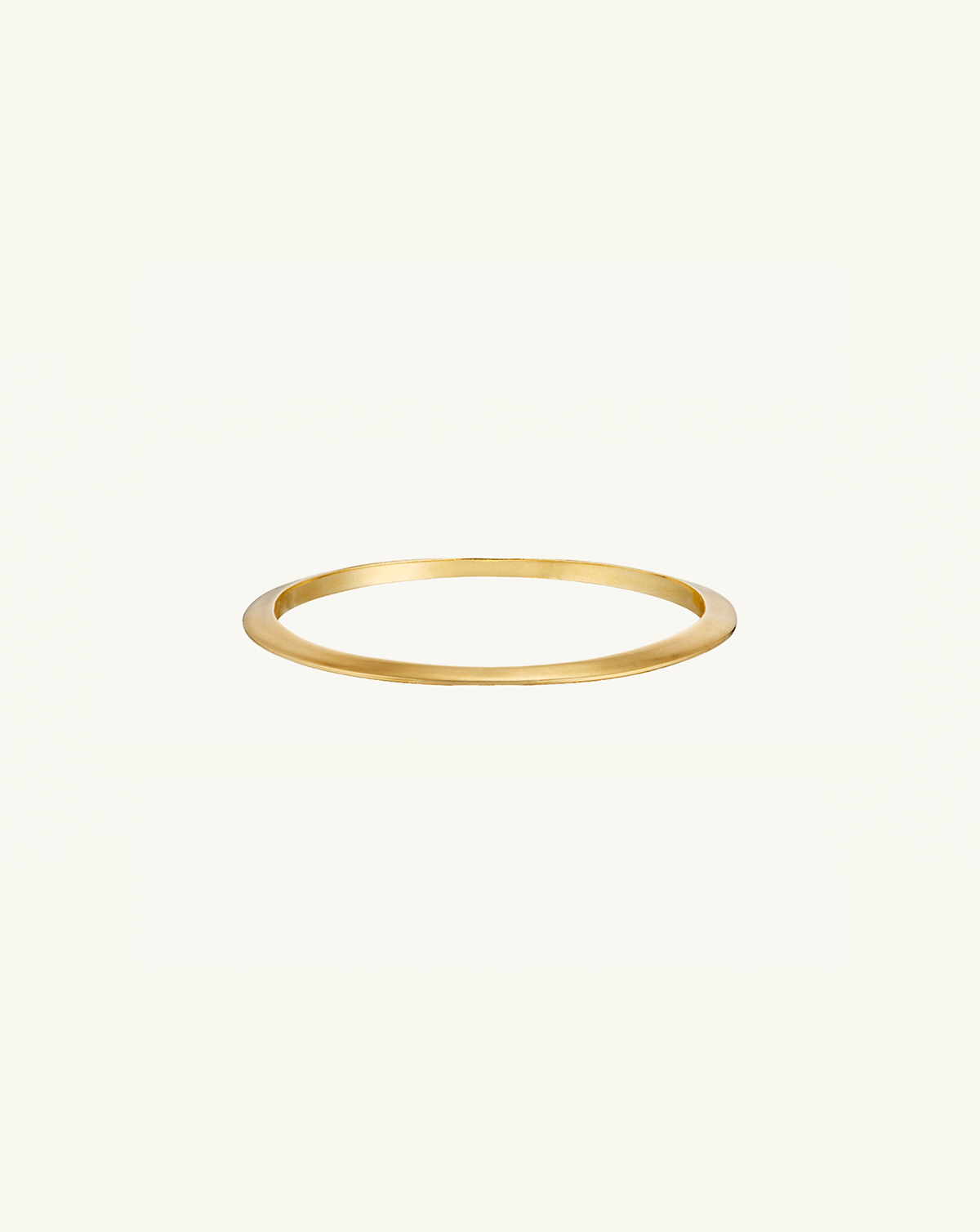 Product image of i seira gold oval bangle on flat surface