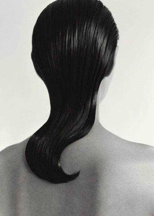 Reference image of a model's back, showing her slicked back hairstyle.